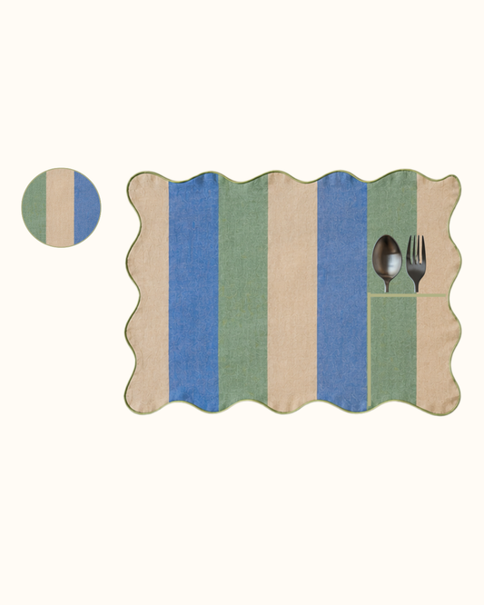 EVOO linen set of eight, four placemats and four coasters in green through cream into blue, piped in olive.